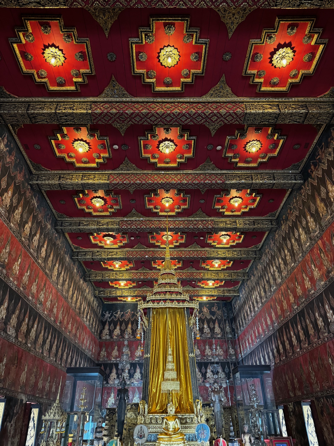 Red ceiling detail inside a Bangkok temple