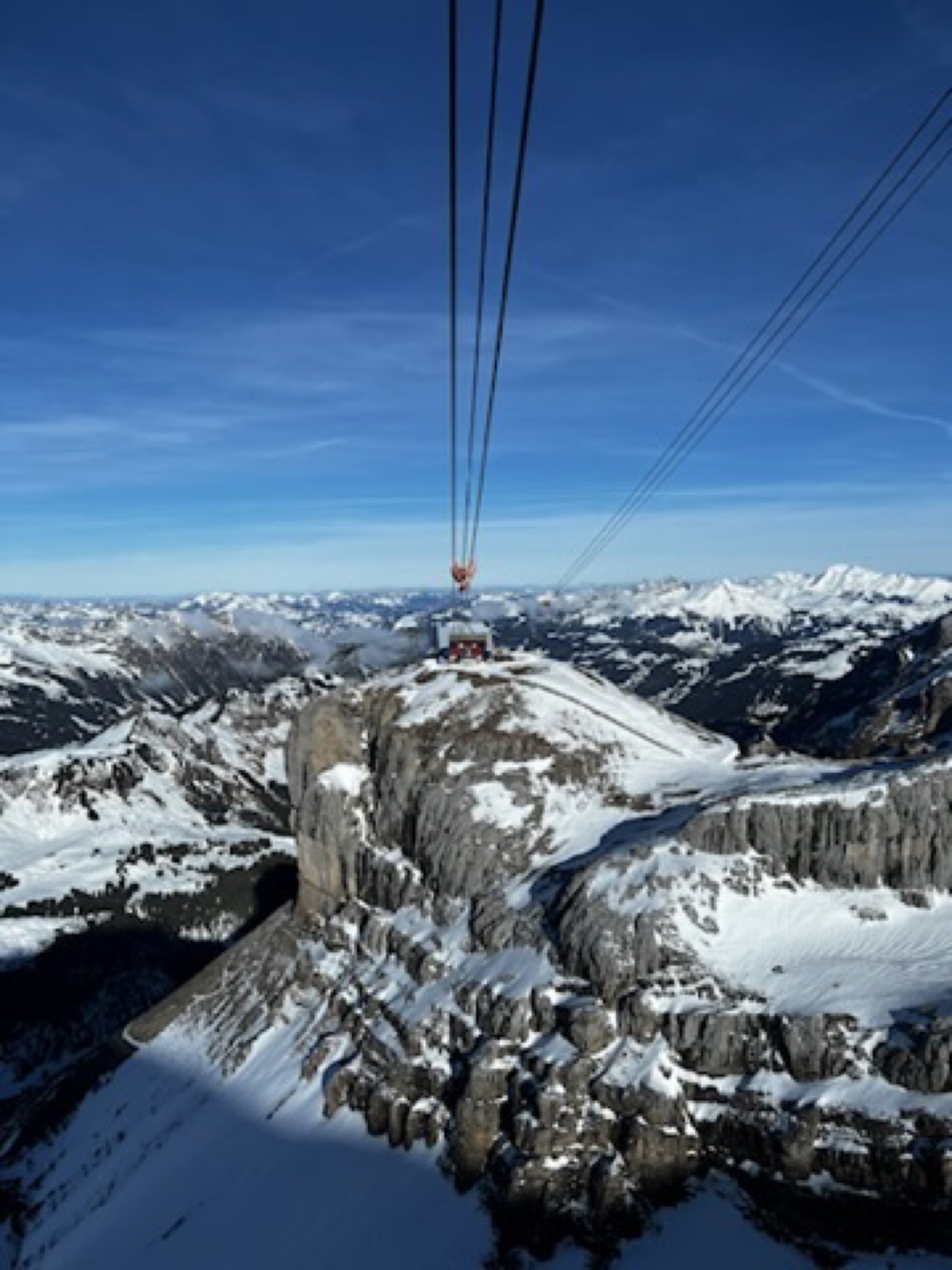 Alpine cable ride with snowy scenery