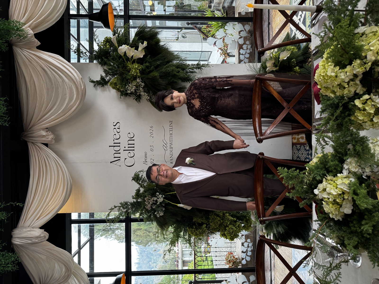 Wedding ceremony room with floral decoration and the couple at the front