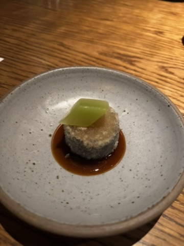 Scallop and kedondong course served in a small stoneware bowl