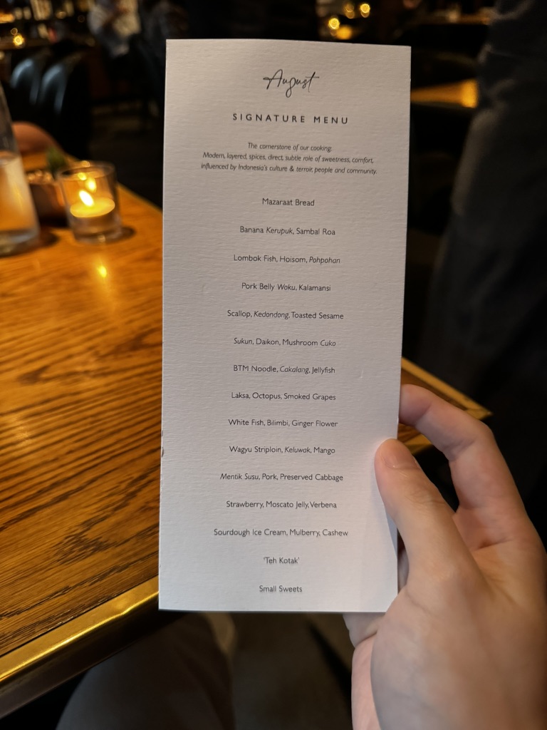 August Jakarta signature menu card listing the tasting courses
