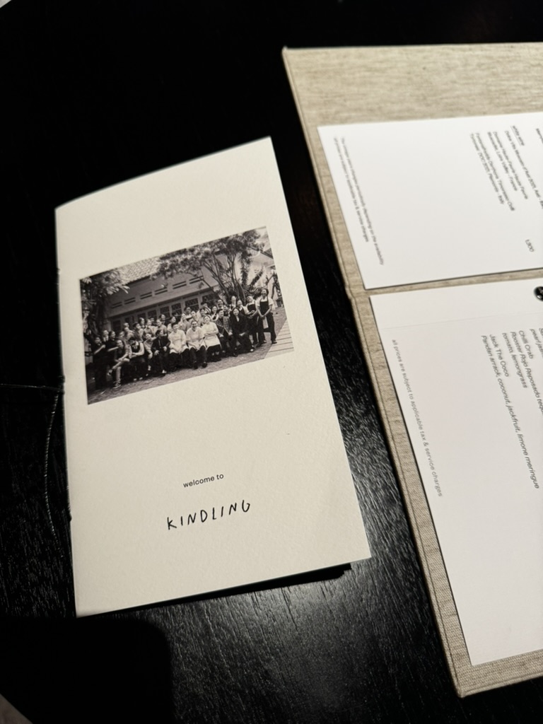 Kindling welcome card placed beside the menu