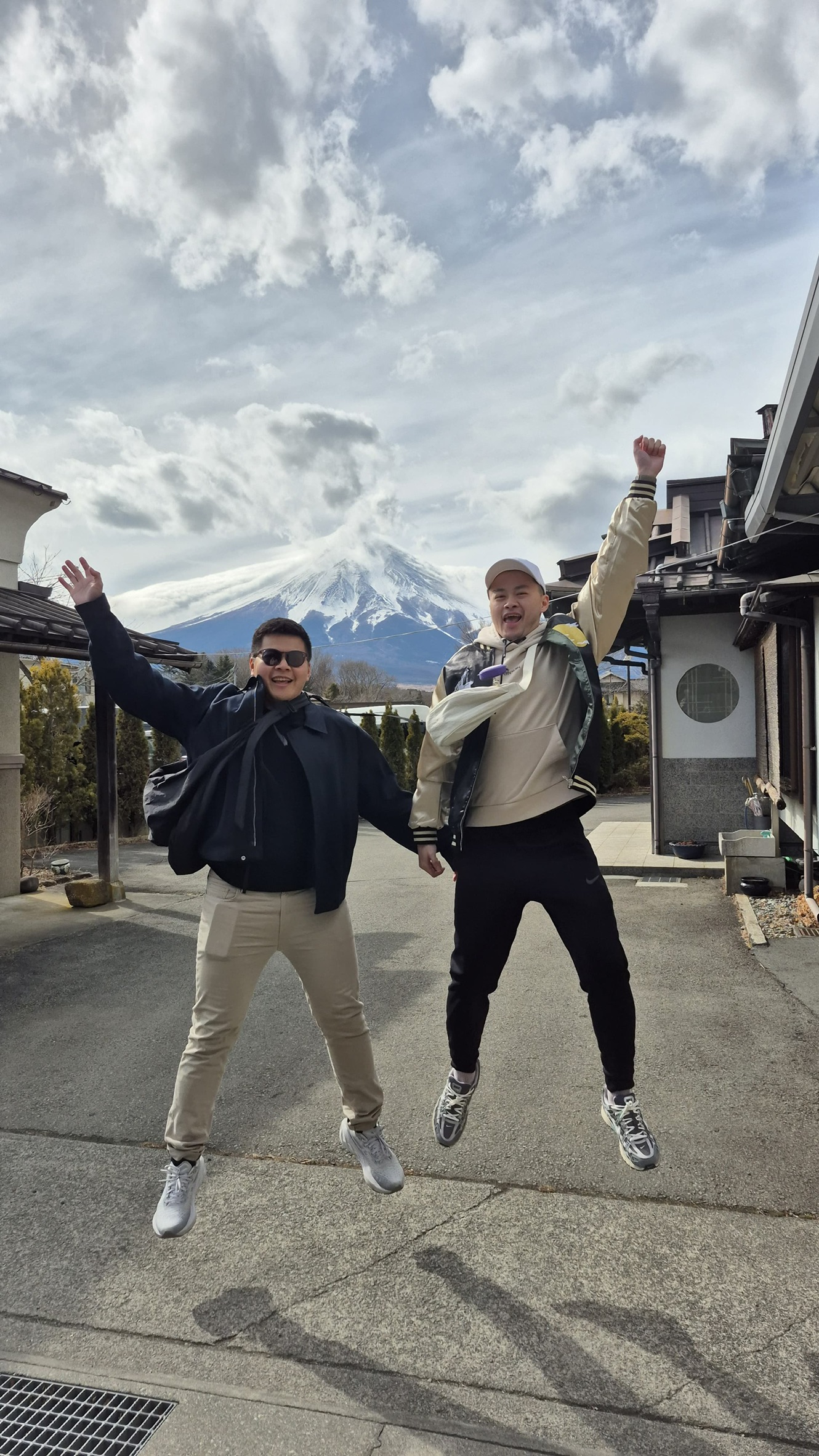 Two people jumping with Mt. Fuji in the background