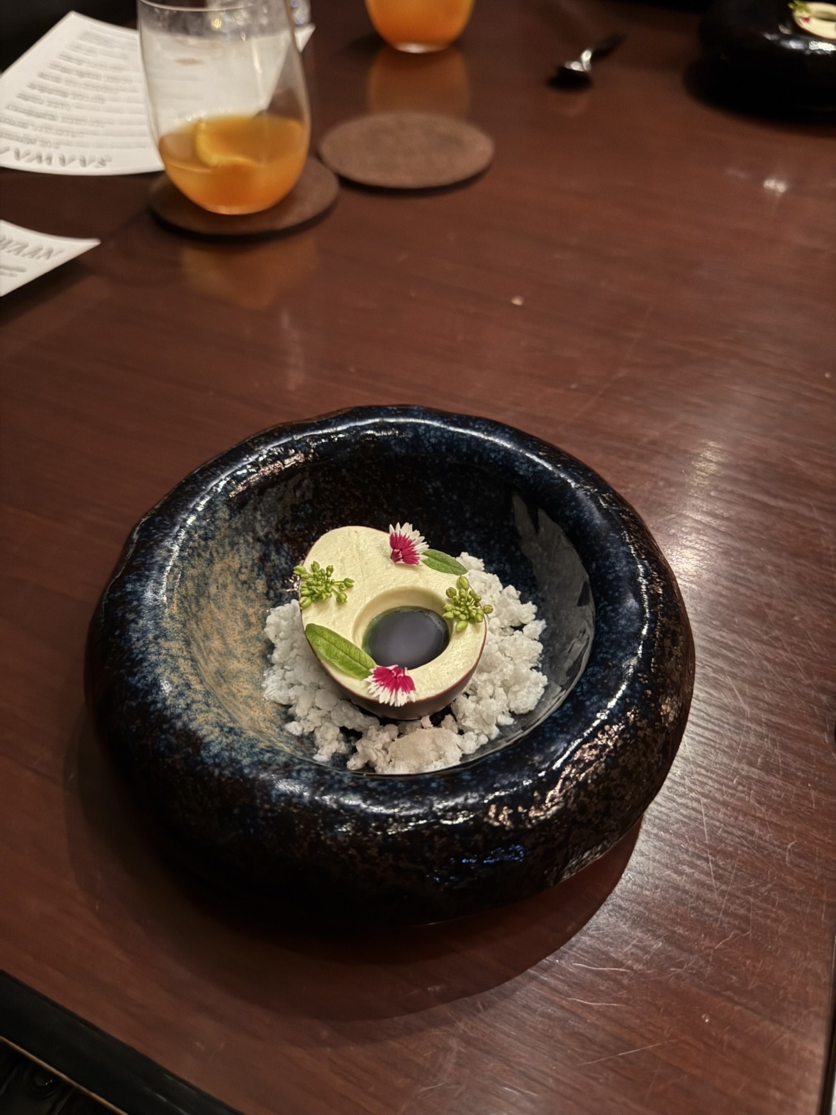 A composed Saawaan course in a dark blue bowl on a wooden table