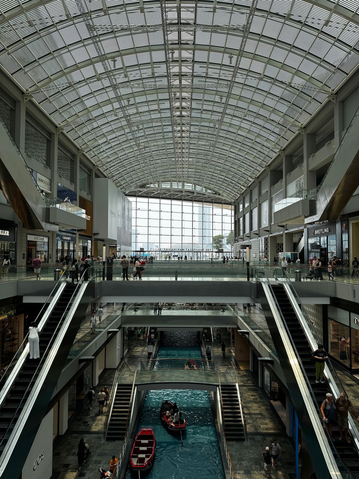 The canal and escalators inside the Shoppes at Marina Bay Sands in Singapore