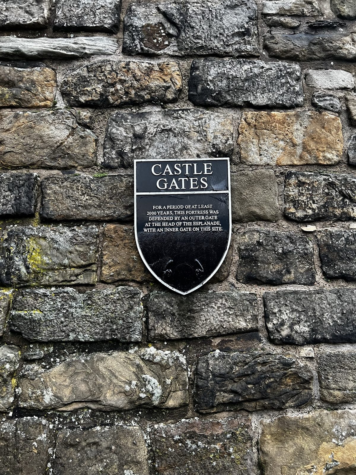Castle Gates sign on a stone wall in Edinburgh