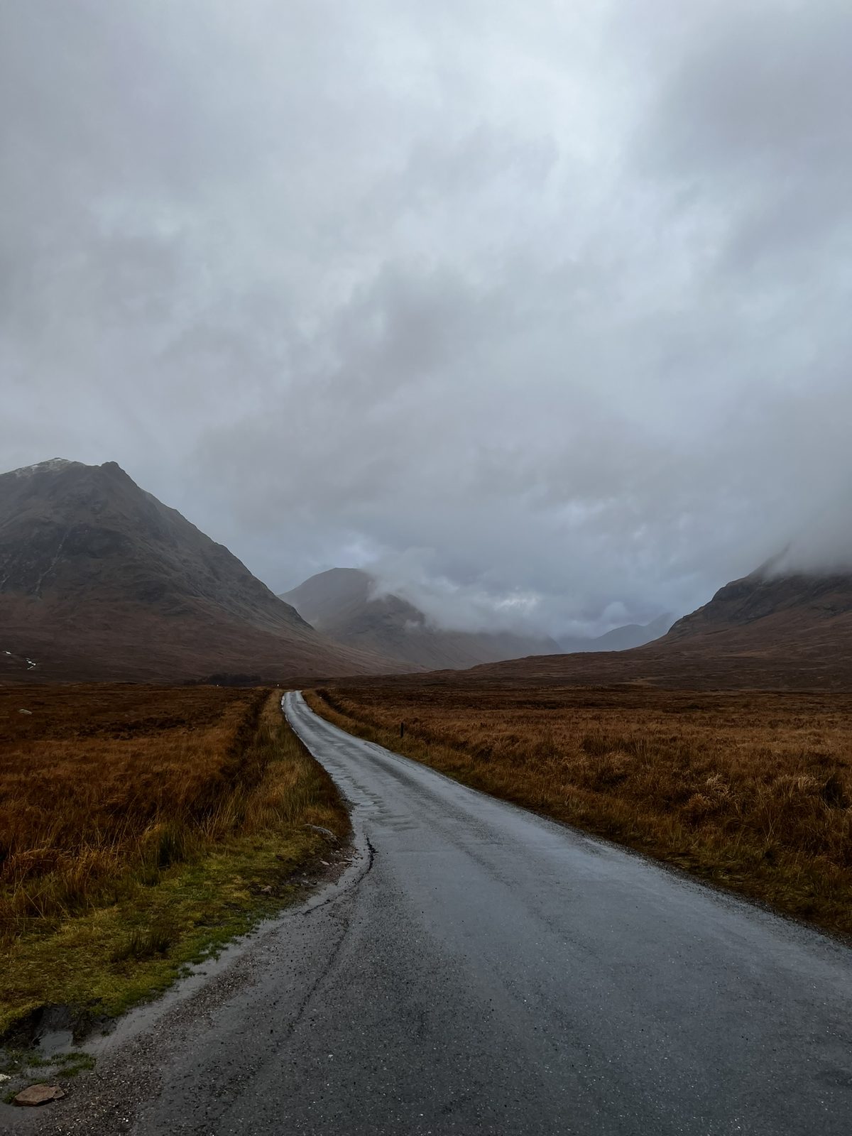 Moody road winding through the Scottish Highlands