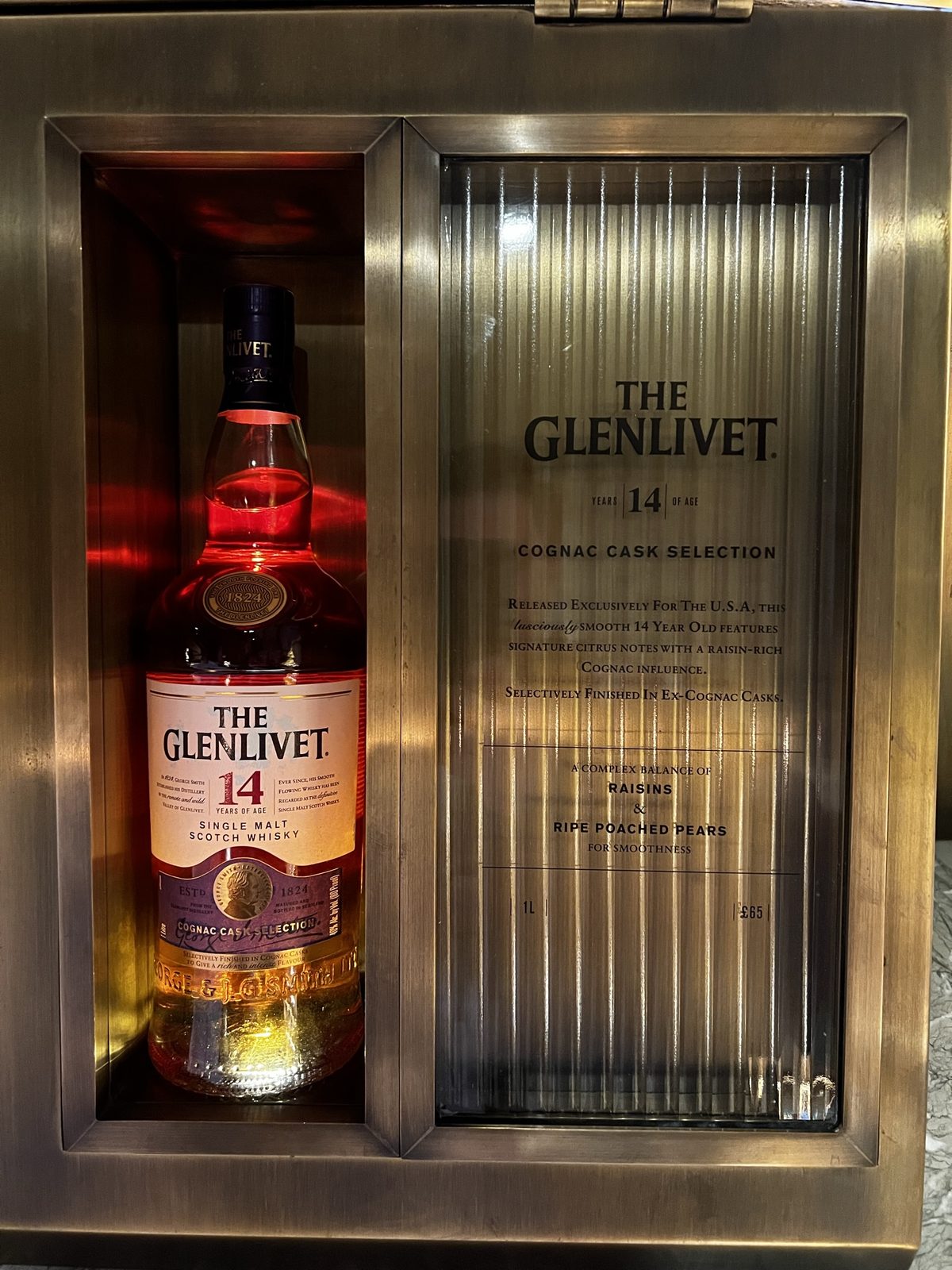 Glenlivet bottle display glowing in a whisky room