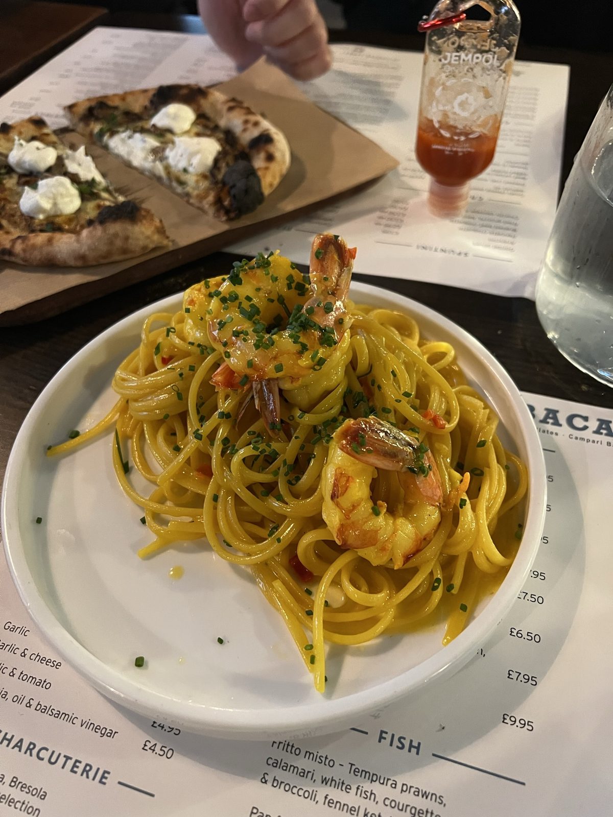 Pasta and pizza on a restaurant table in Manchester