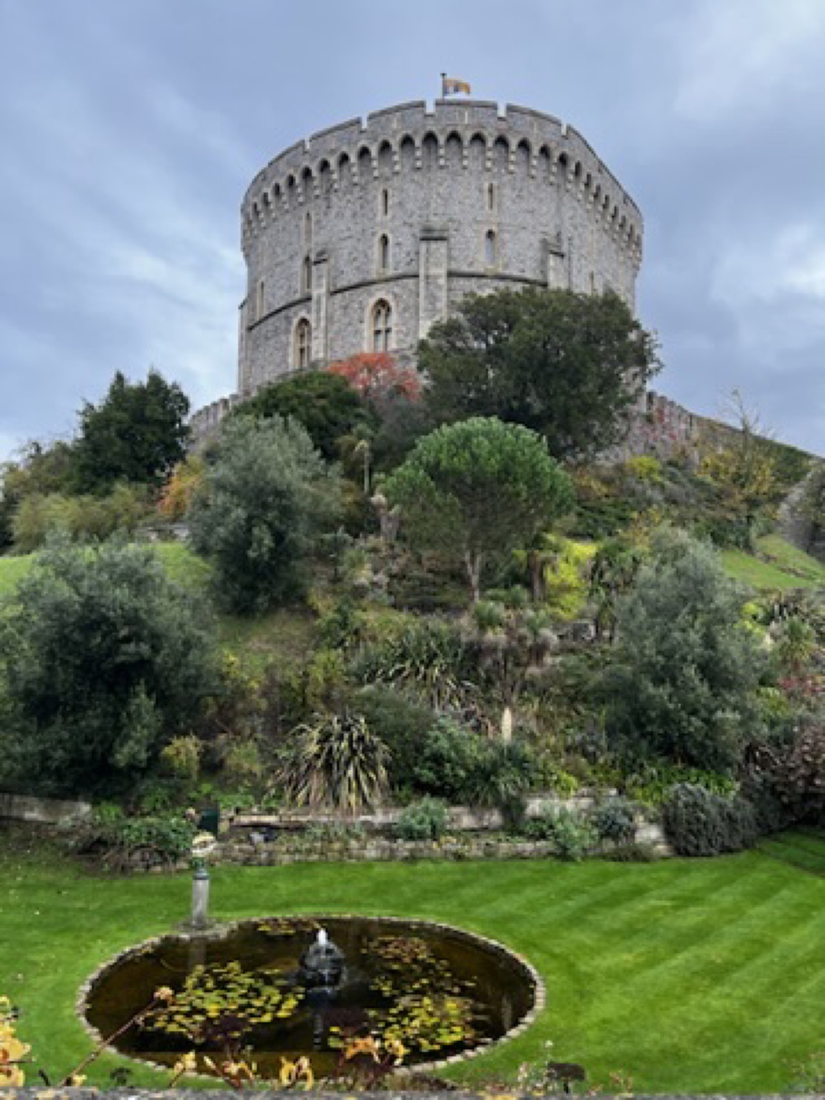 Windsor's round tower rising over a green lawn